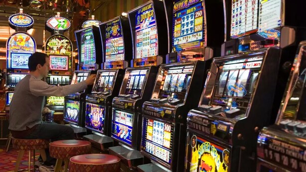 A row of slot machines in a casino. - Ventanas del Lago (Puerto Varas)