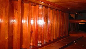 A wooden corridor with a polished finish and a sloped ceiling. - Ventanas del Lago (Puerto Varas)