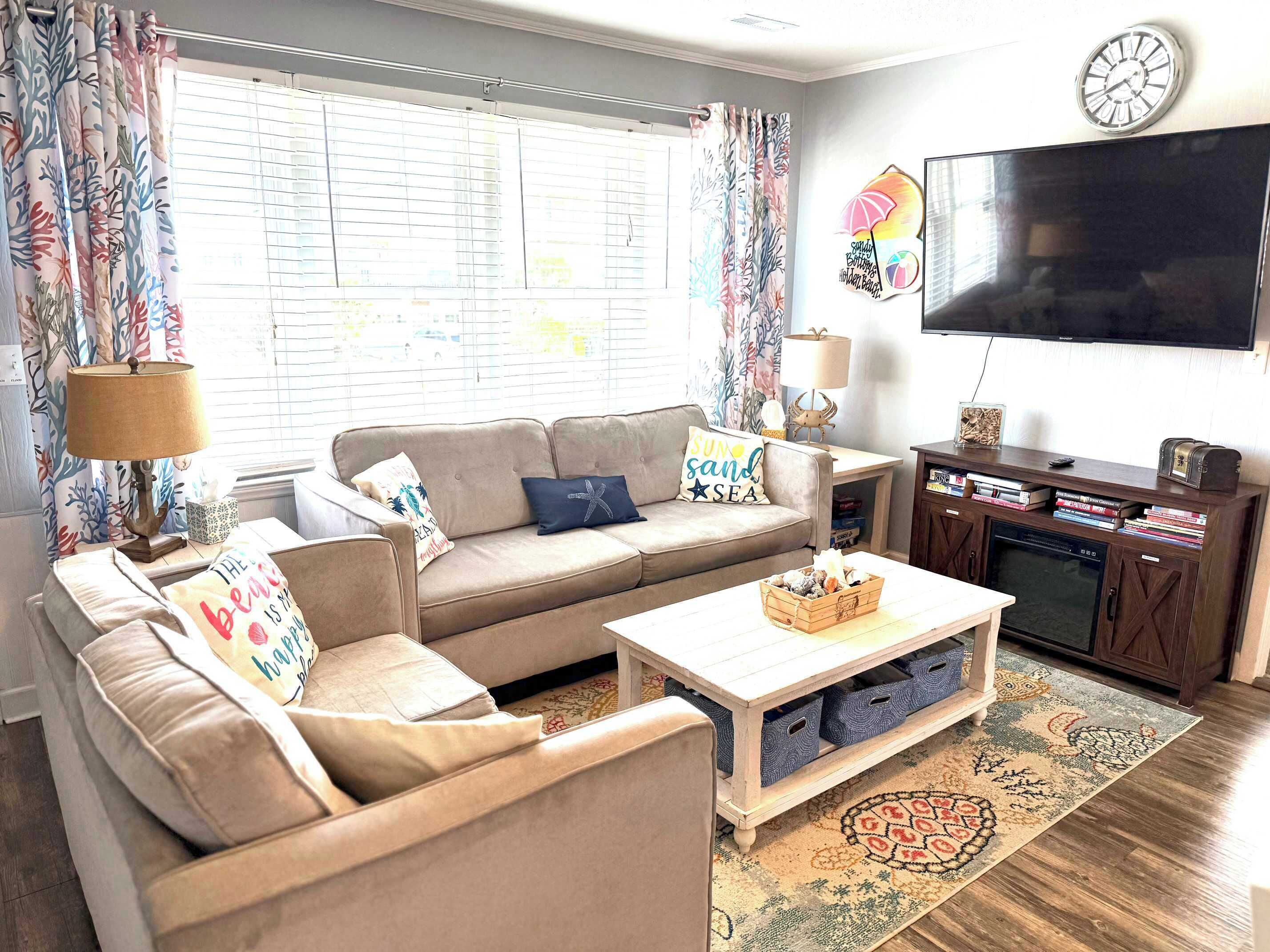 A living room with a sofa, coffee table, TV, and a bookshelf.