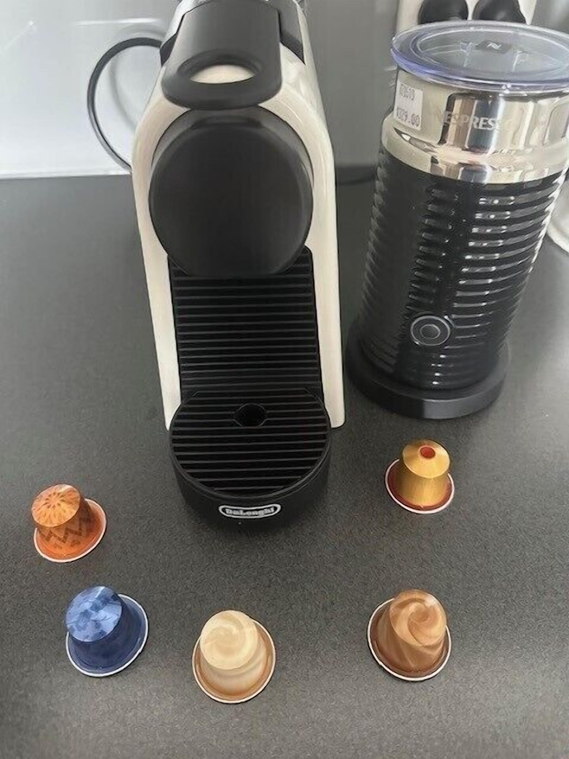 A coffee maker and a thermos on a countertop.