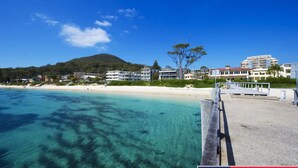 A coastal hotel with multiple buildings, a sandy beach, and clear blue waters. - Beautiful water views of Shoal Bay (Shoal Bay)