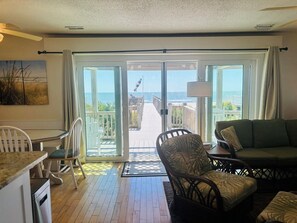 Enjoy ocean views from the spacious living area with a sliding glass door leading to a deck and seating area.