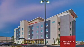A multi-story hotel with a modern design, featuring a prominent entrance and a sign indicating it is a TownePlace Suites by Marriott.