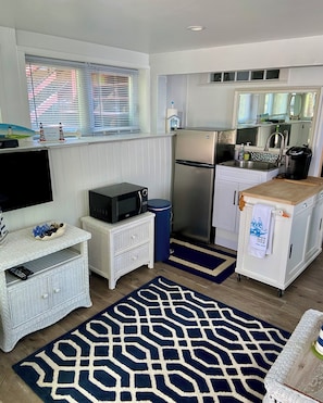 A compact kitchen with a refrigerator, microwave, and sink. - Waterfront Quiet Retreat, Plymouth, Pet Paradise, Private Beach, Sleeps 4 (Plymouth)