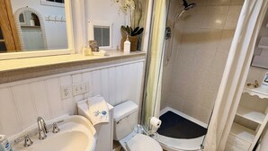 A modern bathroom with a double sink, toilet, and walk-in shower. - Waterfront Quiet Retreat, Plymouth, Pet Paradise, Private Beach, Sleeps 4 (Plymouth)