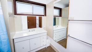A bathroom with a white vanity, a mirror, and a shower area. - Castaways 8 Shoal Bay Beachfront Retreat (Shoal Bay)