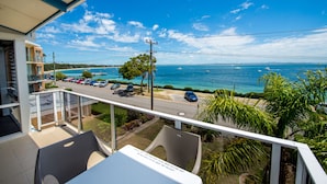 A balcony with a view of a beach and the sea. - Castaways 8 Shoal Bay Beachfront Retreat (Shoal Bay)