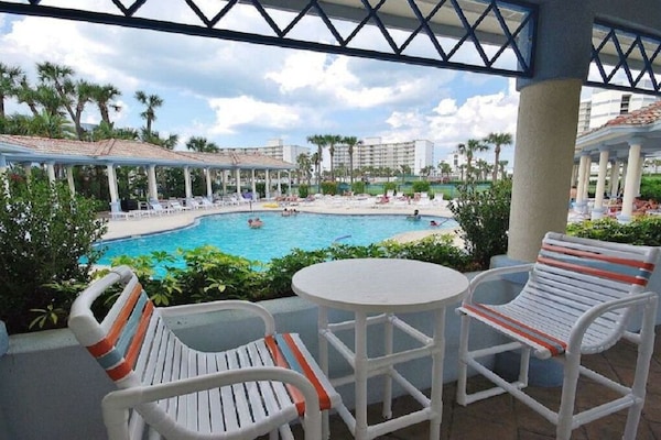 Covered pool areas with gas grills and lots of tables