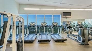 A gym with treadmills, a stationary bike, and a weight machine.