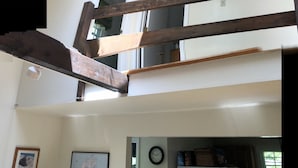 A staircase with wooden handrails leading to an upper floor.