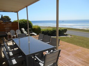 A covered outdoor dining area with a view of the ocean. - Edith's Magnificent Views Dog friendly Off Peak Special! (Point Turton)