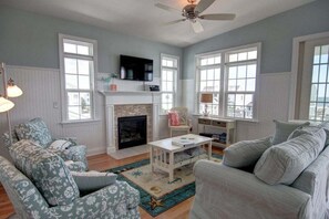 TV, fireplace - Experience seaside charm at "Welcome Home" in Holden Beach, a spacious 4BR retreat! (Holden Beach)