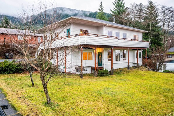 A two-story house with a balcony, a front porch, and a garage. - Ketchikan Home: Bay Views, 1/2 Mi to Hiking Trails (Ketchikan)