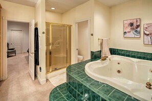 A bathroom with a large bathtub, a shower with a glass door, and a toilet. - Ketchikan Home: Bay Views, 1/2 Mi to Hiking Trails (Ketchikan)