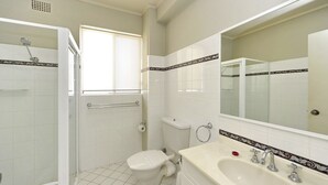 A bathroom with a shower, toilet, sink, and a large mirror. - Del Rae, Unit 12/25 Shoal Bay Road - North-facing apartment overlooking the Bay (Shoal Bay)
