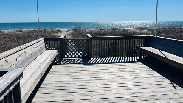 A wooden boardwalk leading to a beach with a clear view of the ocean. - Enjoy oceanfront bliss at When Pigs Fly, a spacious 4BR gem in Holden Beach, NC. (Holden Beach)