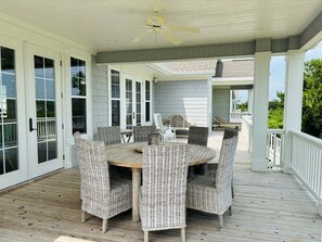 Outdoor dining - Gray Goose is a professionally designed waterway home (Holden Beach)