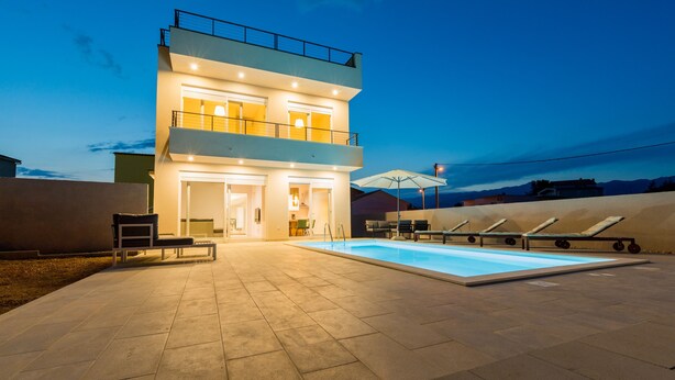 A modern two-story building with a swimming pool, outdoor seating, and a balcony. - Villa Lele - Pool, Sea & Mountain View (Novigrad)