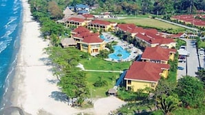 A resort with beachfront villas, a swimming pool, and a beach.
