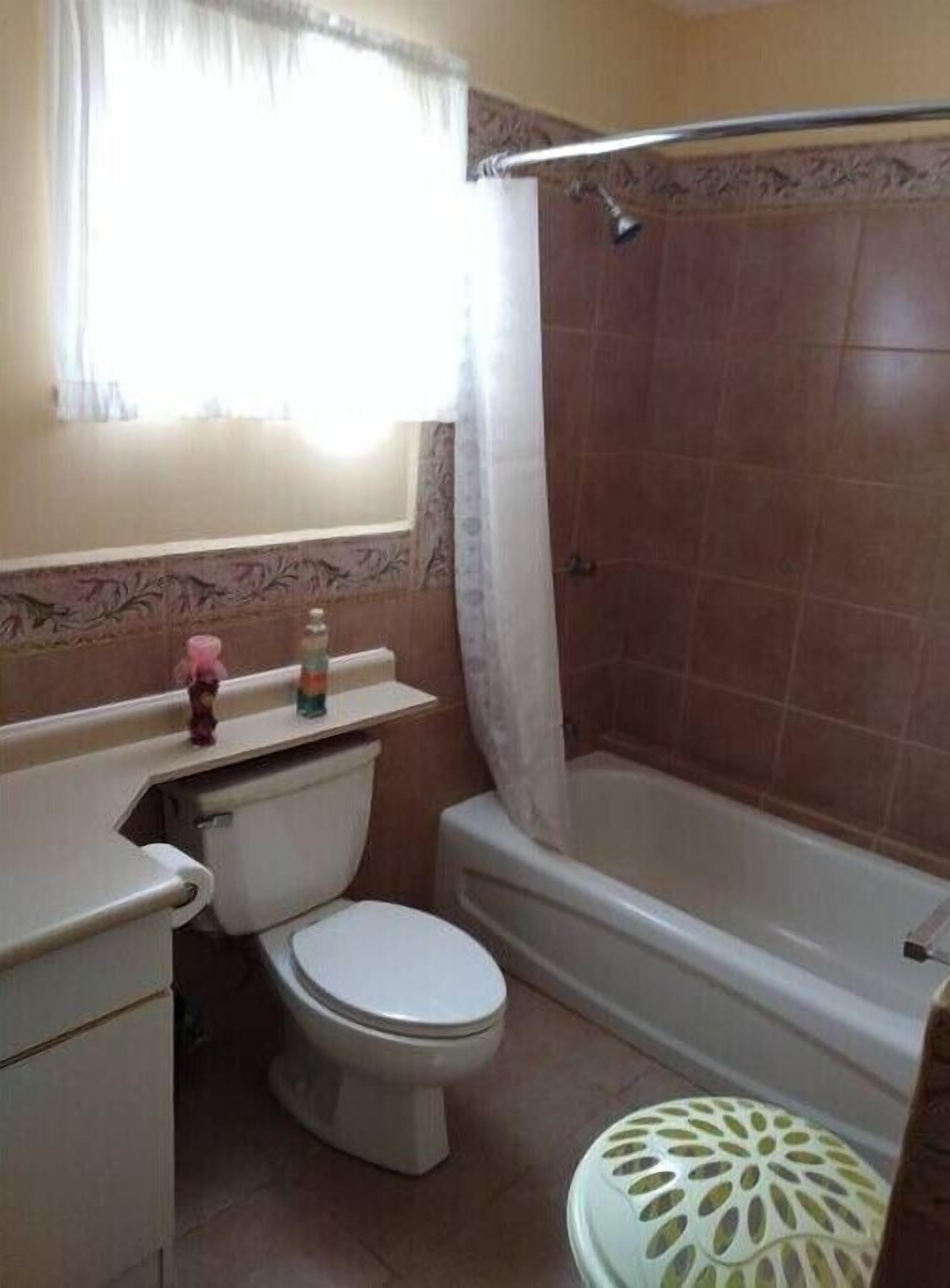A bathroom with a toilet, sink, and bathtub.