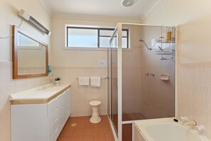 A bathroom with a shower, toilet, sink, and a mirror. - Shoal Bay Av 3 Top Floor with Balcony (Shoal Bay)