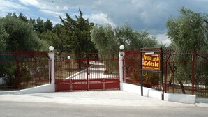 A gated entrance to a property named "Villa Celeste" with a sign indicating it offers apartments and vacation rentals.