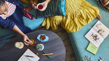 A cozy living room with a sofa, a coffee table, and a book.