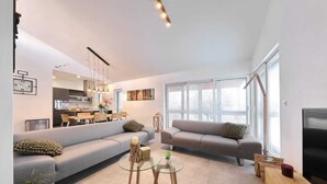 A modern living room with a sofa, a glass coffee table, and a TV. - An oasis of tranquility Villa Divinus, with heated pool (Polača)