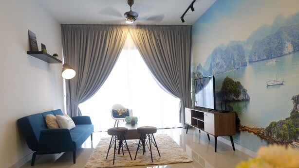A modern living room with a blue sofa, a coffee table, and a TV on a wooden stand. - Bora Residence (Johor Bahru)