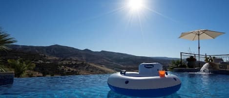 Relax by the pool with a refreshing swim or lounge on the raft.
