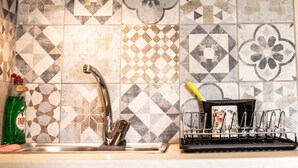 A kitchen with a tiled backsplash, a stainless steel sink, and a dish rack. - Lucky 2 - Great location, close to the most beautiful beaches of Cyprus! (Paralimni)