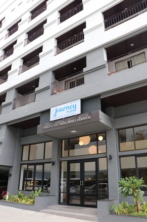 A modern building with a sign for 'Journey Hotel' and a large glass entrance. - Journeyhub Pattaya Central (Pattaya)