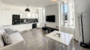A modern apartment with a kitchen, dining area, and living room. - Cosy 1-BR fully renovated - heart of Cannes, Croisette 1 mn Olam Properties (Cannes)
