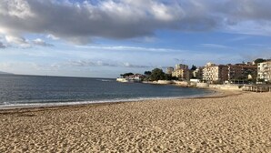 A sandy beach with a clear sky and buildings in the background. - Countryside in town, beautiful beach and all amenities  (Ajaccio)