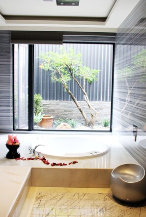 A modern bathroom with a bathtub, a window with a view of a garden, and a marble floor. - Yin Shui Han Motel (Kaohsiung)