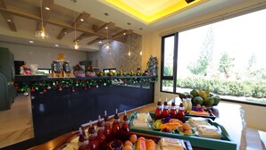 A buffet area with various food items and a Christmas tree. - Floral Land B&B (Shoufeng)