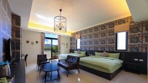 A modern hotel room with a large bed, a desk, and a chair. There is a TV, a window with a view, and a chandelier. - Floral Land B&B (Shoufeng)