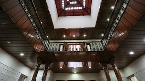 A wooden staircase with a glass ceiling and metal railings. - Matthuga (Siddapur)