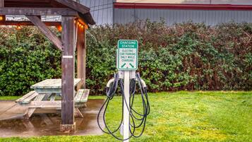 A charging station with a sign indicating it is for electric cars only while charging.