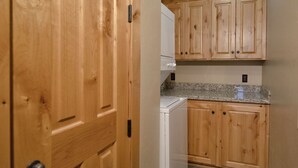 A kitchen with wooden cabinets, a granite countertop, and a built-in oven. - Teton Springs Condo #206 in Victor w/ A/C, W/D, WiFi, Balcony, Grill & Garage (Victor)