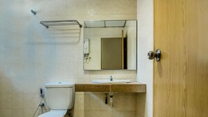 A bathroom with a toilet, sink, mirror, and shower. - Super OYO 828 Comfort Hotel Shah Alam (Shah Alam)