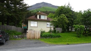 A single-story house with a sloped roof, a front porch, and a garage.