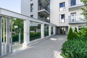 Residents enjoy balconies with glass railings, offering outdoor space to relax amidst well-maintained greenery.