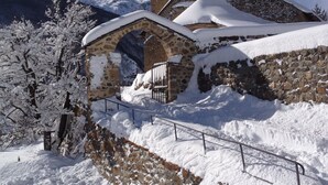 A snow-covered church with a bell tower and an arched entrance.