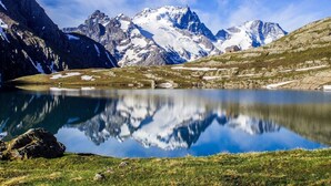 A mountain landscape with a clear lake reflecting the peaks.