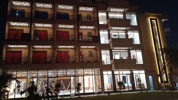 A multi-story hotel with large windows and balconies. - JJK Rukmini Vilas Hotels and Banquets (Muzaffarpur)