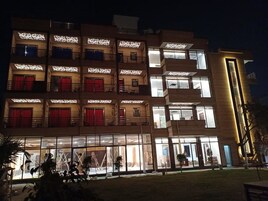 A multi-story hotel with large windows and balconies.