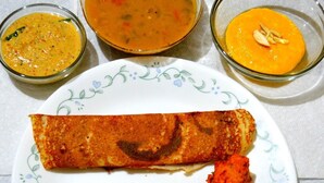 A plate with a rolled dish, two round items, and three small bowls of different sauces. - JK Rooms 133 Hotel Prime Inn (Ankleshwar)