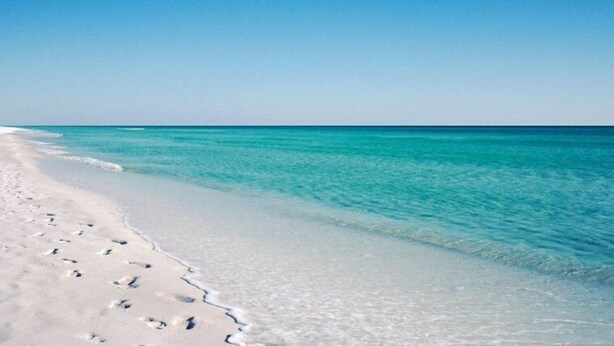 A beach with clear turquoise water and white sand. - Discover Blue Surf 9, Pet-Friendly 2BR Townhouse Beach Service Included Miramar Beach! (Destin)