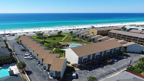 A beachfront hotel with multiple buildings, a swimming pool, and a beach view. - Discover Blue Surf 9, Pet-Friendly 2BR Townhouse Beach Service Included Miramar Beach! (Destin)